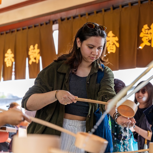 Student partakes in a ceremonial purification ritual at the Senso-ji temple in Tokyo