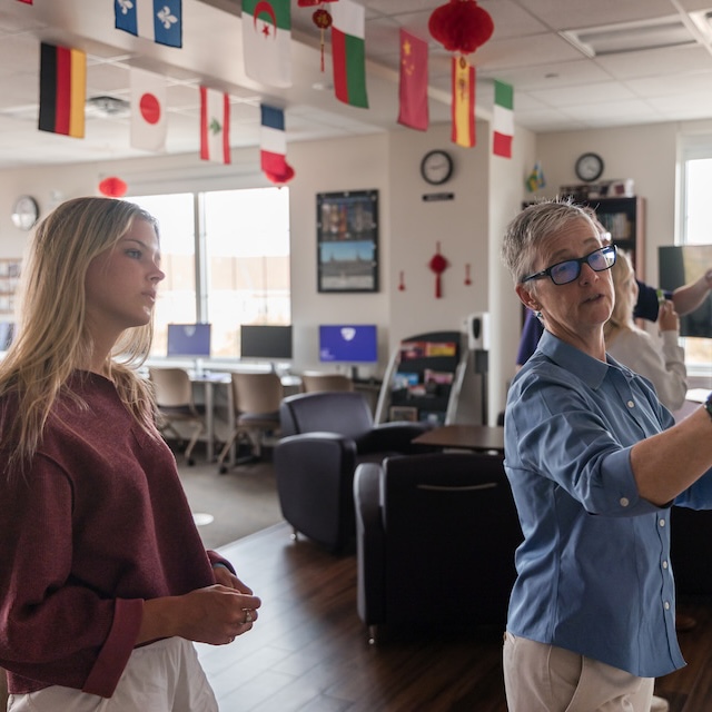 Student watches teacher in language lab