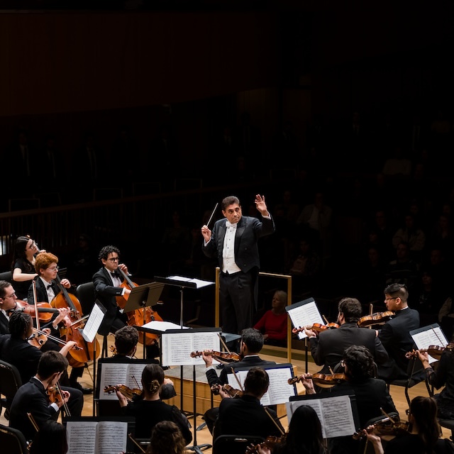 A conductor leads TCU student orchestra