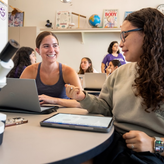 Two students sitting at a table in a science education class