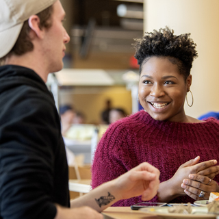 TCU students laugh together at lunch in the student union