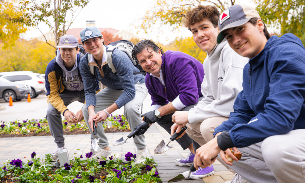 Chancellor Pullin with students planting flowers