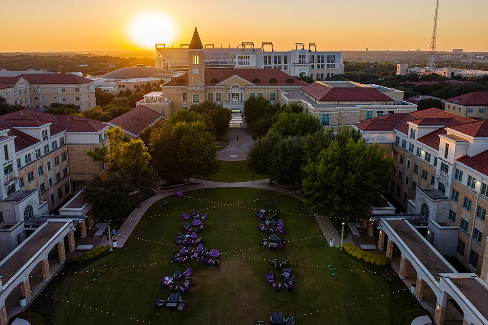 A bird's-eye view of the Campus Commons with purple tables and chairs for students to gather