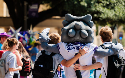 students hugging SuperFrog