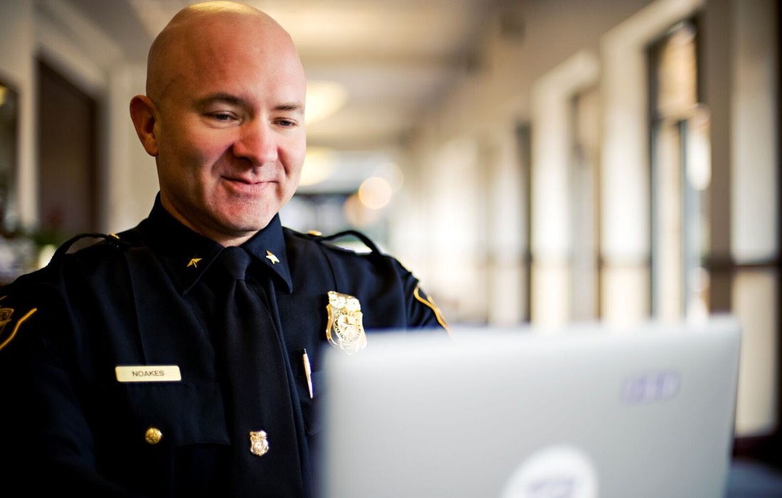 Police officer using a computer