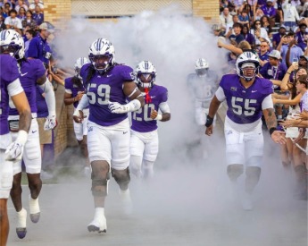 Football players running out of tunnel